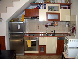 And here's our kitchen, tucked underneath the steps. We didn't have a good place for our microwave or toaster oven, so their stacked on top of one of our dining room chairs.