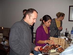 Davor and Elisa bringing in food hot off the grill - Cevapcicis and chicken wings!