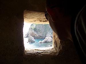 Looking out through a porthole in a fortress tower.
