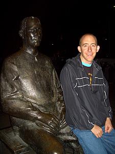 Jay standing next to a statue.