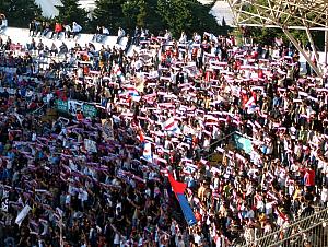 Torcida fans holding up their scarfs for a song.