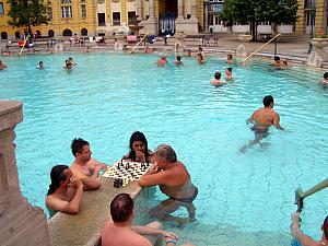 Hungarian gentlemen enjoying a game of chess. This pool was 102 degrees farenheit. A giant pool / hot tub! 