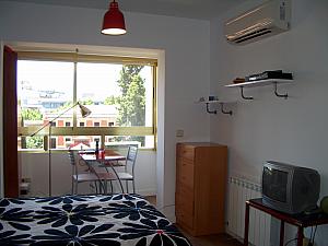 Just past the bed is a little nook with a table and a nice giant window.