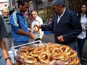 Street vendors selling interesting-looking bread.