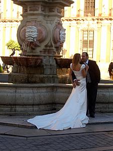 Seville - bride and groom - the groom has a handful!