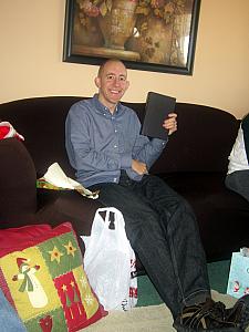 Jay opening a gift -- a Michael Connelly book (just finished reading it last night, 4/13!)