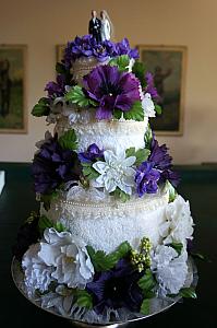 A pretty wedding cake made out of towels; the cake topper was used on Kelly's grandsparents' wedding cake.