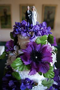 A pretty wedding cake made out of towels; the cake topper was used on Kelly's grandsparents' wedding cake.