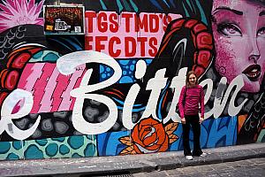 Kelly posing in front of some of the graffiti