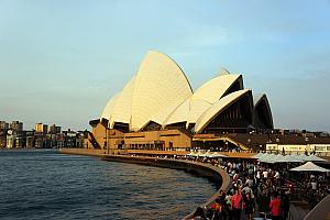 The cafes and restaurants are buzzing with activity in front of the opera house.