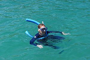 Kelly snorkeling. Most everyone used noodles, which were helpful in keeping us afloat without having to dog paddle and risk kicking/damaging the coral.