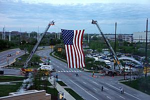 Looking at our hotel room windows, watching two cranes raise a giant American flag