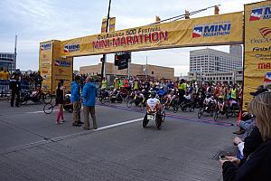 Wheelchair racers lead the pack to start the half marathon. The wheelchair racers finish faster than the runners -- the winner finishes in under an hour!