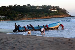 Watching a fishing boat come in from the ocean. 