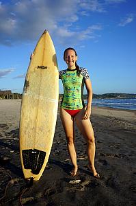 Kelly modeling her board and rash-guard shirt.
