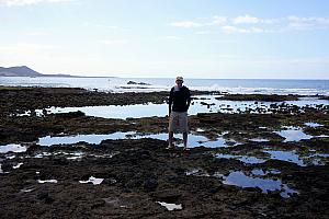 Jay walking along the rocks, is very happy to be in shorts!