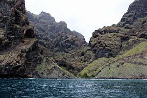 You can see people at the edge of the land. They're waiting for a water taxi to pick them up after hiking down from the top of these cliffs. This sounds like a fun adventure -- maybe next time!