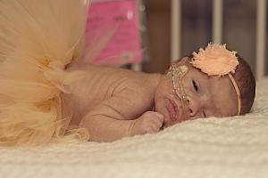 Capri in a tutu and a headband. It doesn't get much cuter than this! She makes her dad's heart melt. (Captured by The Tiny Footprints Project. Thank you!)
