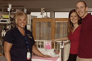 Photo with one of our amazing nurses in the NICU (Captured by The Tiny Footprints Project. Thank you!)