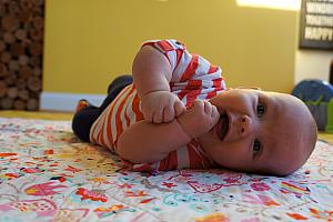Enjoying tummy time, and learning how to roll over from belly to back!