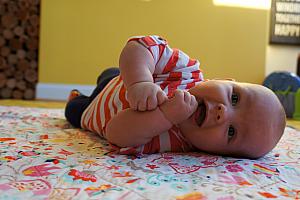 Enjoying tummy time, and learning how to roll over from belly to back!