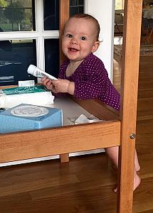 Happily playing with her changing table
