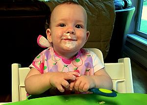 Capri enjoying some yogurt...all over her face.