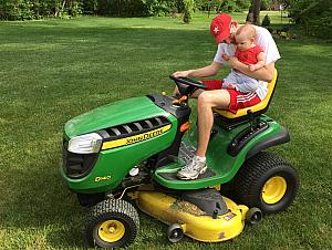 Capri's first lawnmower ride. She wasn't very sure about it -- too noisy.