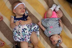 Kenley and Capri laying on a blanket.