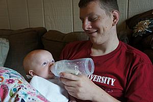 Kevin feeding his baby girl.