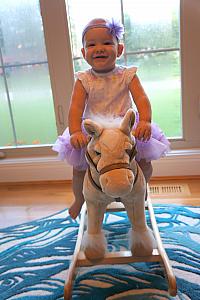 Capri loves her rocking horse. 
