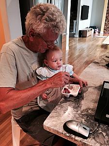 Capri eating some yogurt with Grandpa
