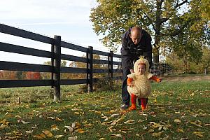 Capri playing in Grammy and Grandpa's backyard in her duckling costume