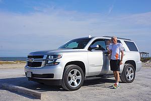Grandpa posing with his beast of a rental car - a 2015 Chevy Tahoe.