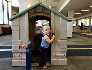 Capri enjoying the playhouse in Mobile Alabama airport