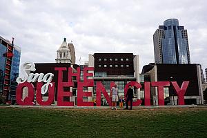 Capri with Grammy and Grandpa at Smale Park downtown - posing at the Sing the Queen City sign.