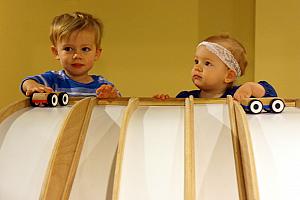 Capri and Thomas racing cars down the hill