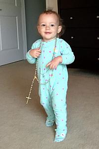 Capri loves to raid Mom's jewelry armoire -- here she is modeling a rosary.