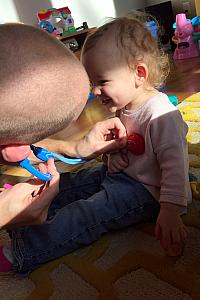 Dad checking Capri's heartbeat with her new doctor kit.