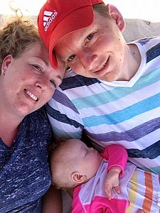 Kenley taking her morning nap while Kevin and Kyleen relax on the beach bed.