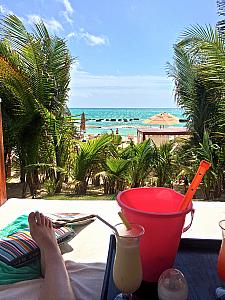 Enjoying a drink while resting in a poolside bed