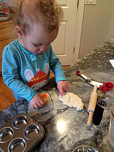 Capri is making some shapes with play dough.