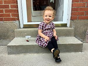 Capri sitting on the stoop with her new pet - a male betta fish -- thanks Uncle Rick!