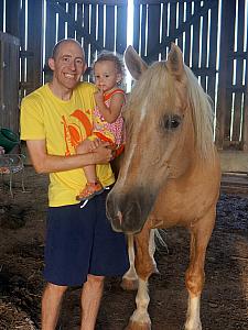 Dad and Capri and a big horse! The vacation house had a barn on the property with two horses, chickens, and even for our weekend baby raccoons and a baby deer! The owner is an animal rescuer.
