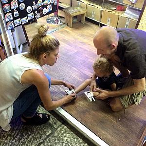 A worker helping Capri change her shoes -- she had put them on backwards :)