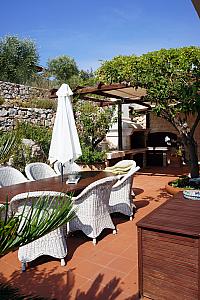 Another terrace at the front of the house, with a big charcoal grill.