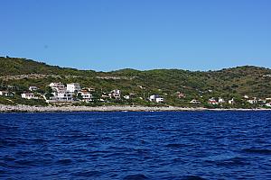 From a boat on the sea looking back to a bunch of seaside houses -- our villa is there.