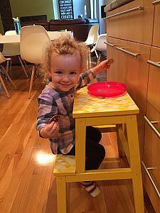 Capri eating some pancakes at her stepstool/kids table