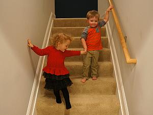 Capri and Benny holding hands down the steps