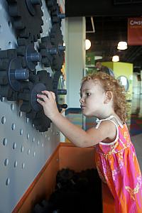 Focused on the gears. Also note in the background dad intensely focused at another exhibit. We all really enjoyed the museum.